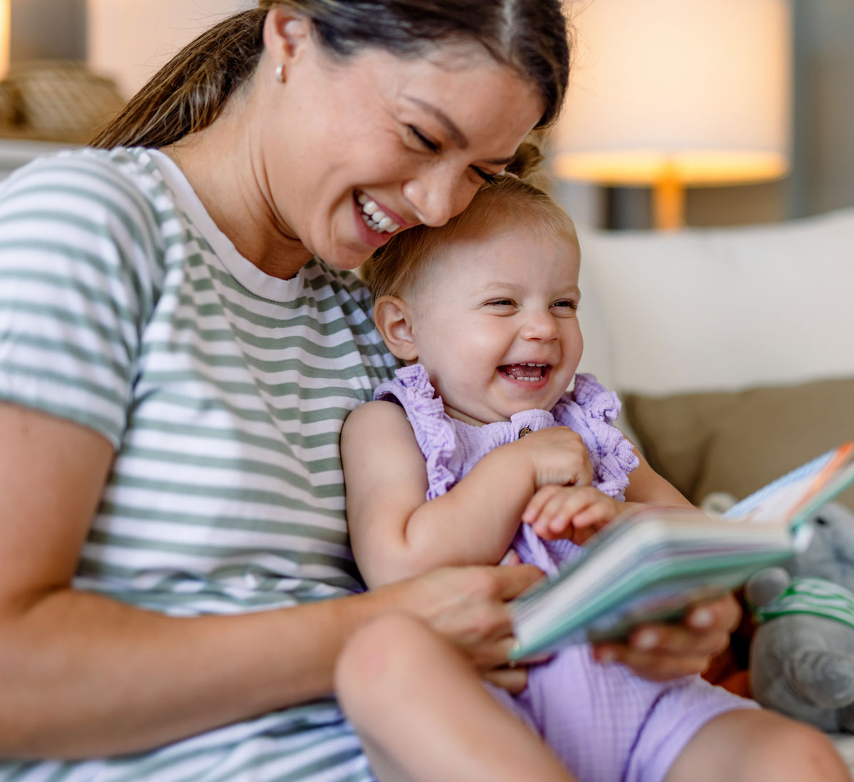 mother reading book with baby