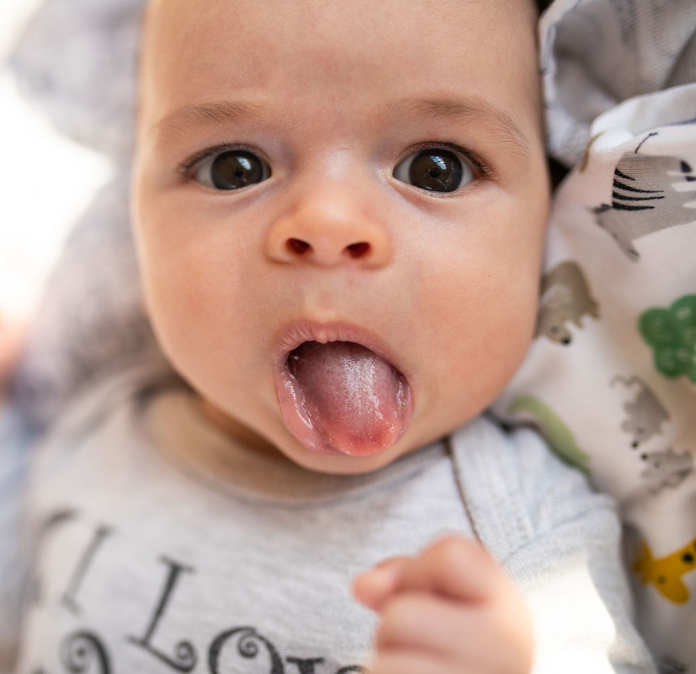Baby with tongue sticking out playfully