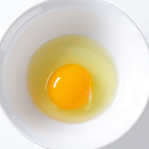 Egg placed in a simple white bowl