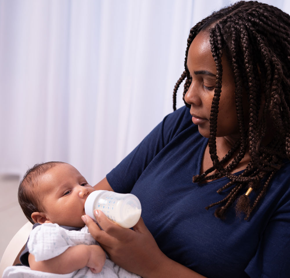 Woman feeding baby with a bottle
