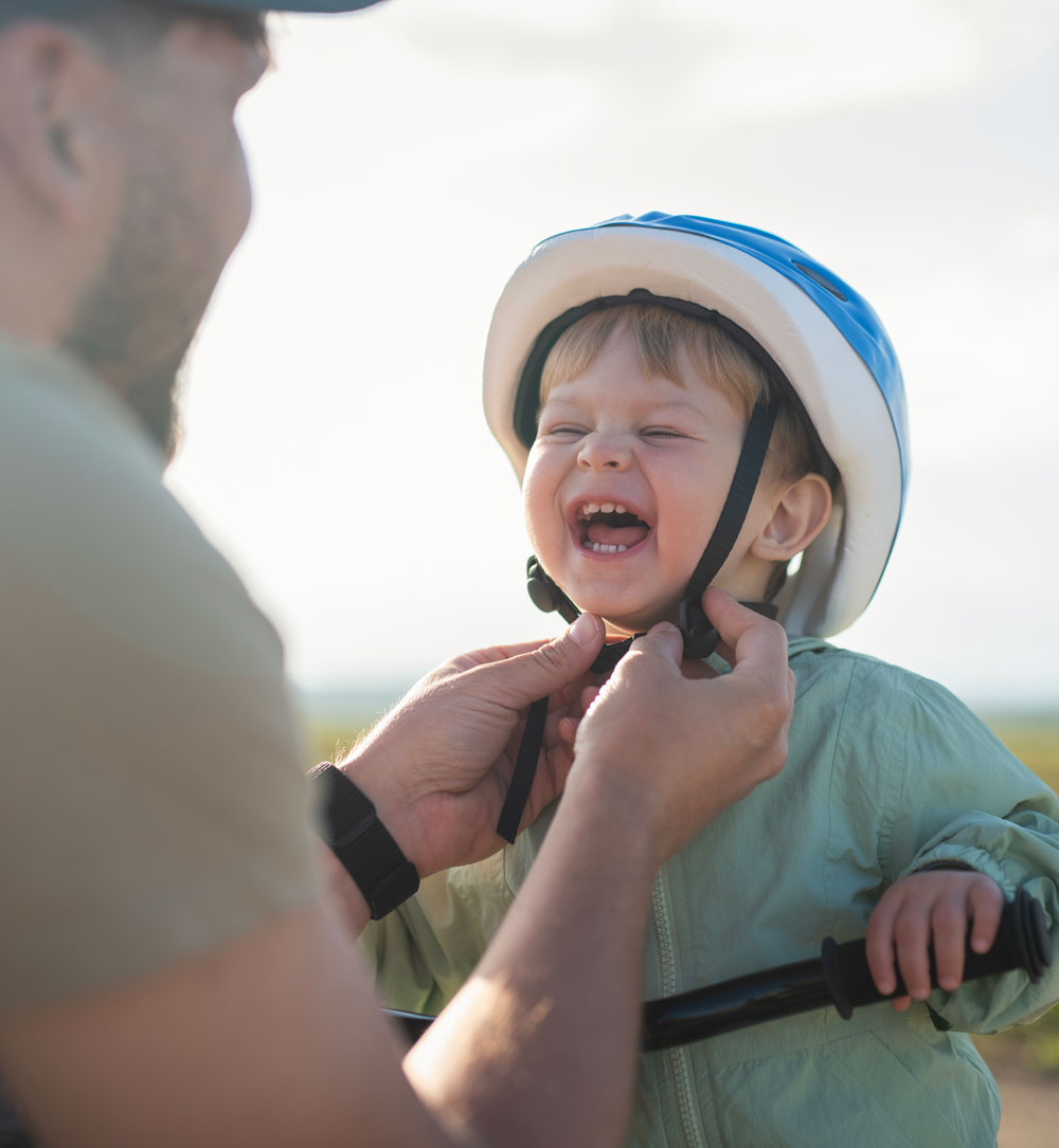 Child smiling while wearing a bike helmet