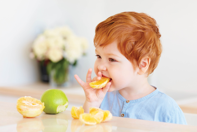 Boy Eating Orange