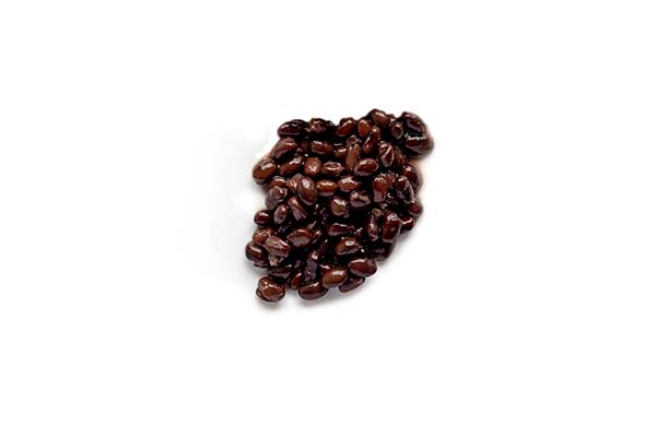 Brown coffee beans scattered on white background