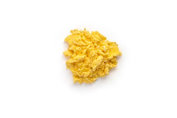 Scrambled eggs on white background, cooked and fluffy