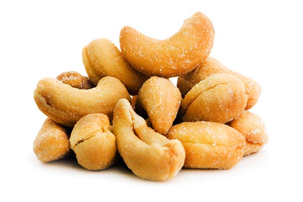 Pile of salted cashews on white background