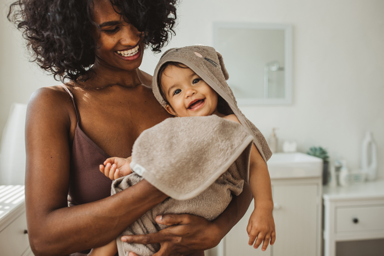 baby in tub with mom playing