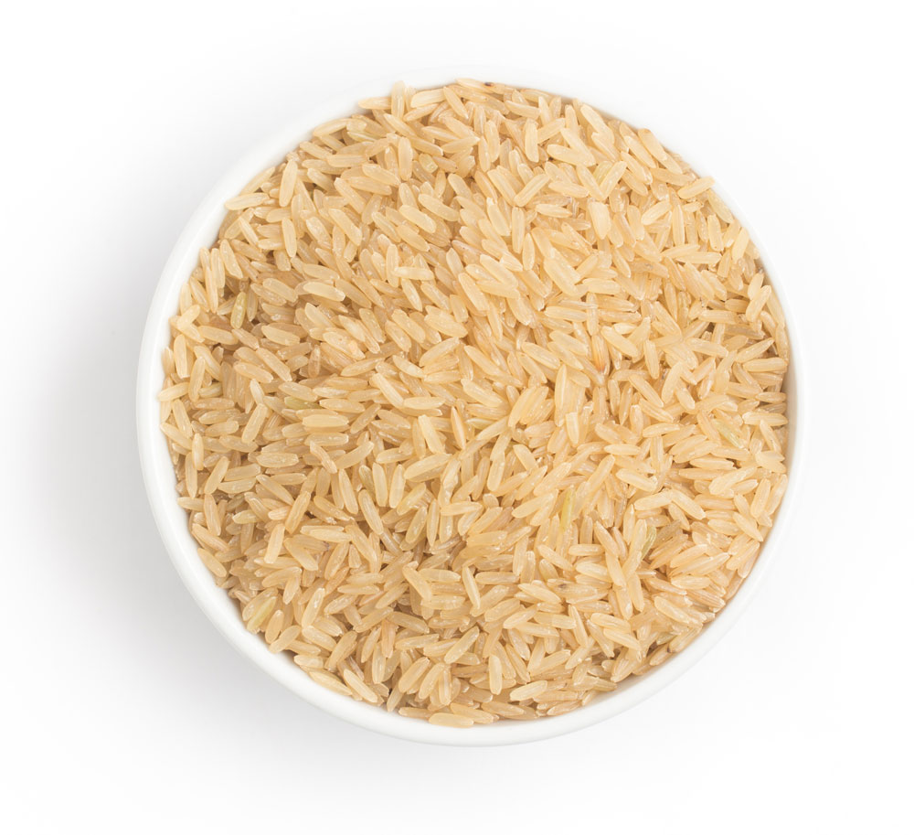 White bowl filled with raw brown rice