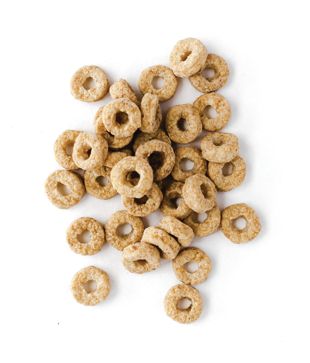 Oat ring cereal scattered on white background
