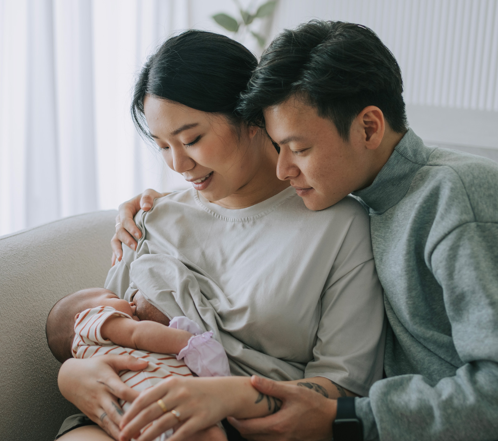 Dad supporting mom breastfeeding
