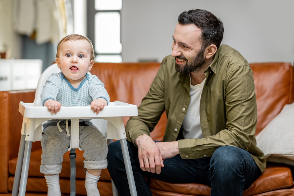 Baby eating with father