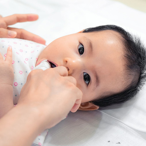 Baby chewing small object