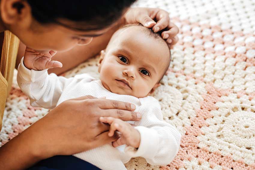 Baby resting with caregiver support