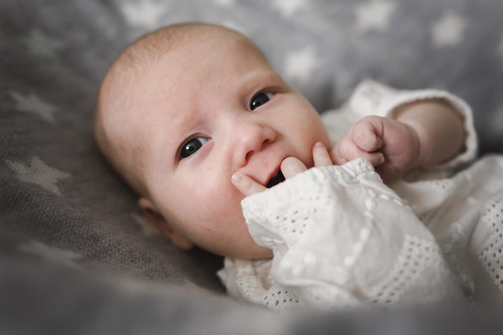 Baby sucking fingers hunger cue