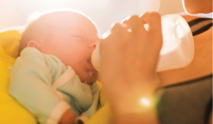 Baby drinking milk from bottle