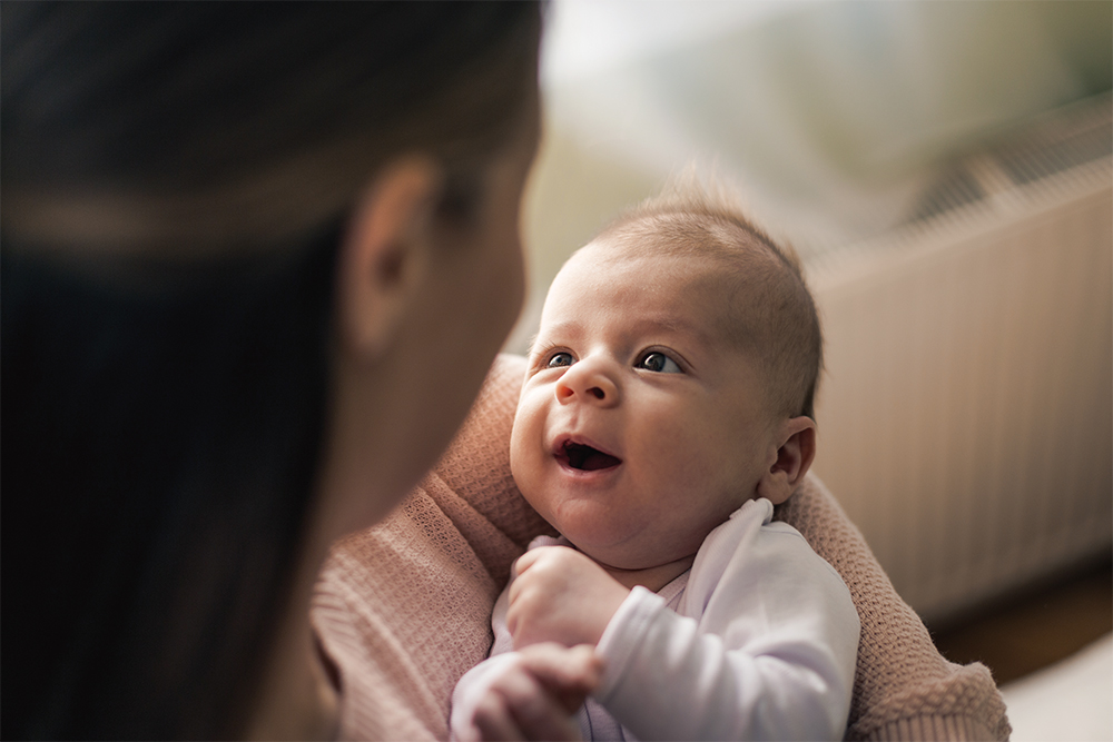 Baby looking at caregiver closely