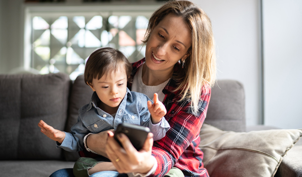 Mother and toddler using mobile